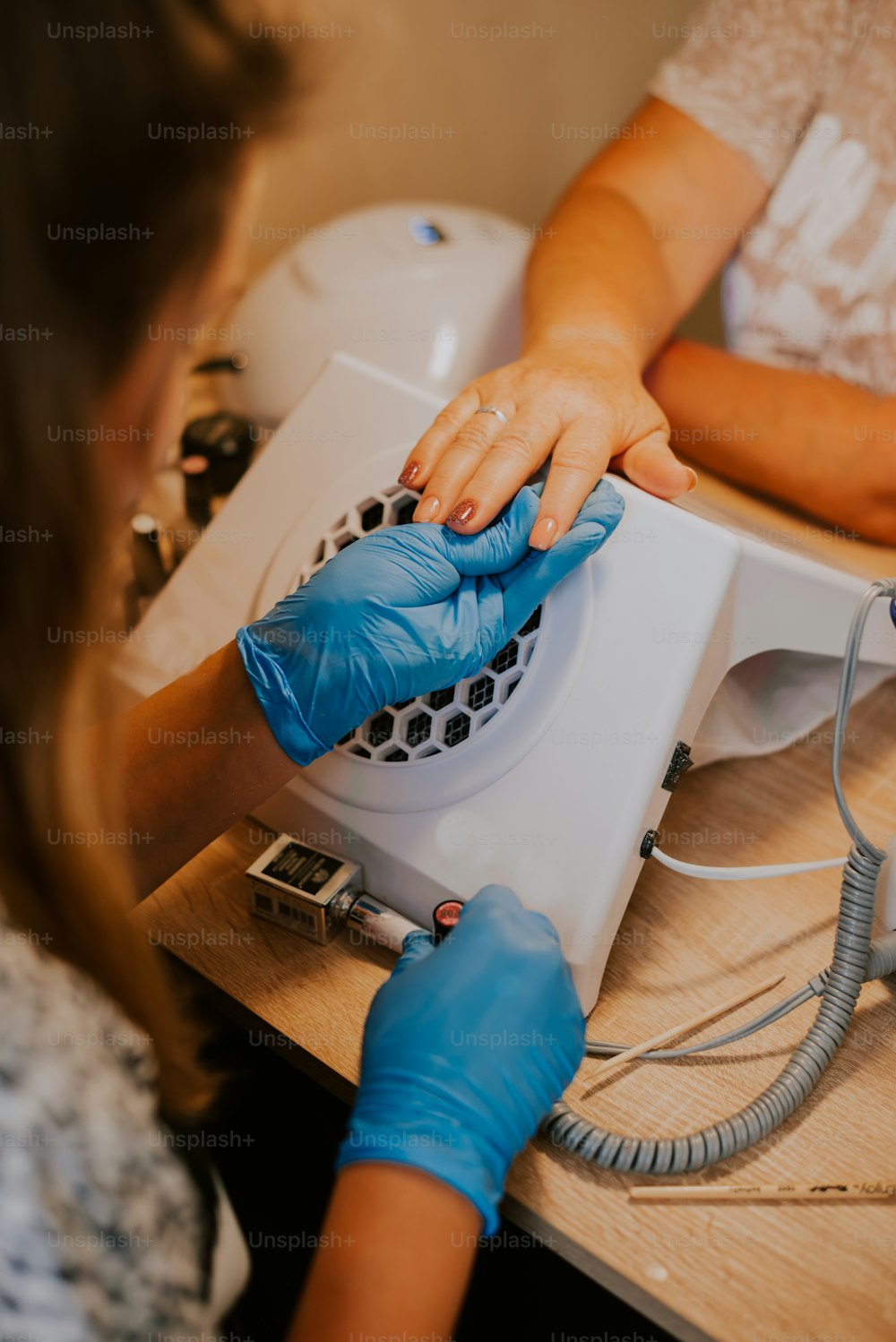 a woman in a white shirt and blue gloves