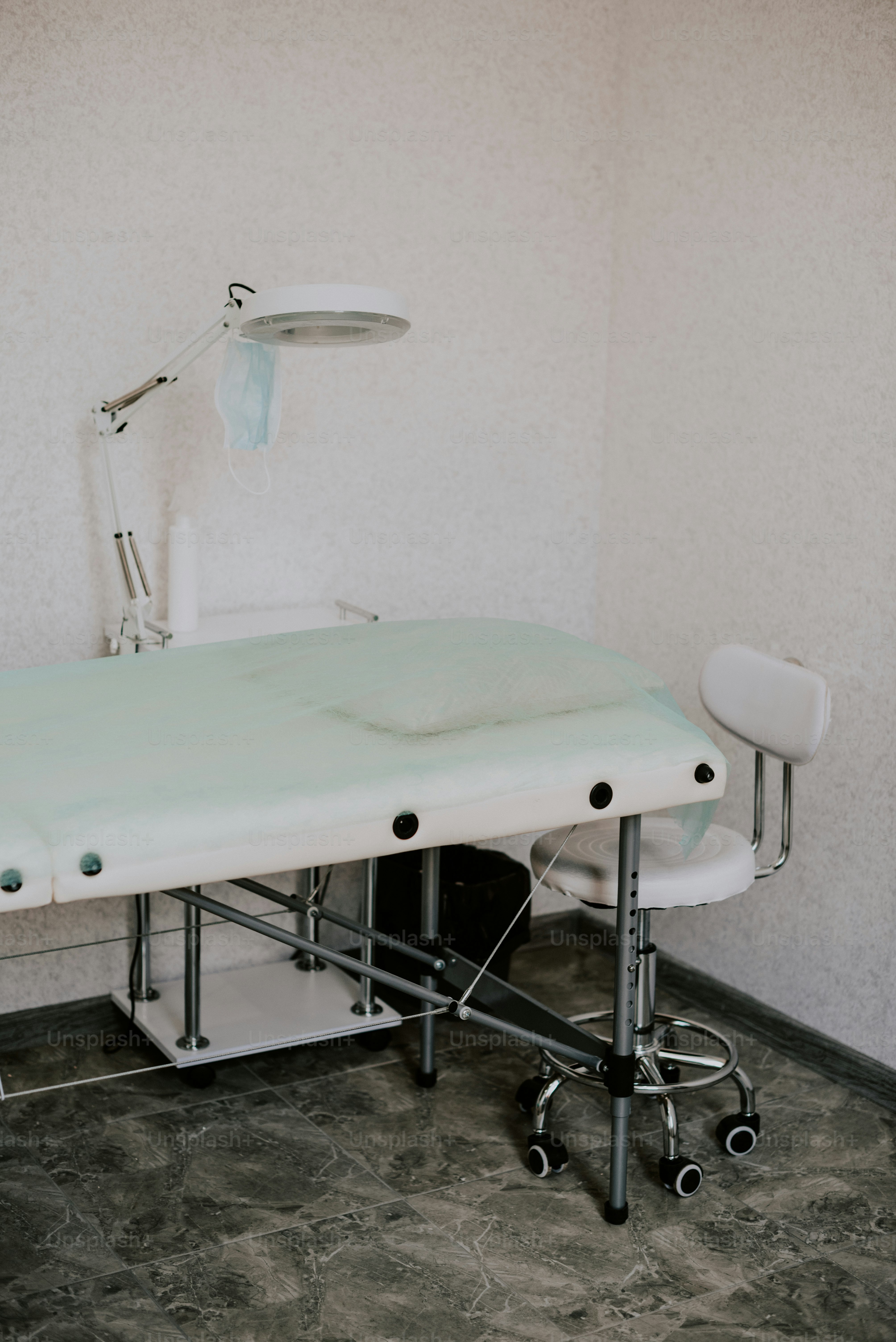 a hospital bed sitting in a room next to a lamp