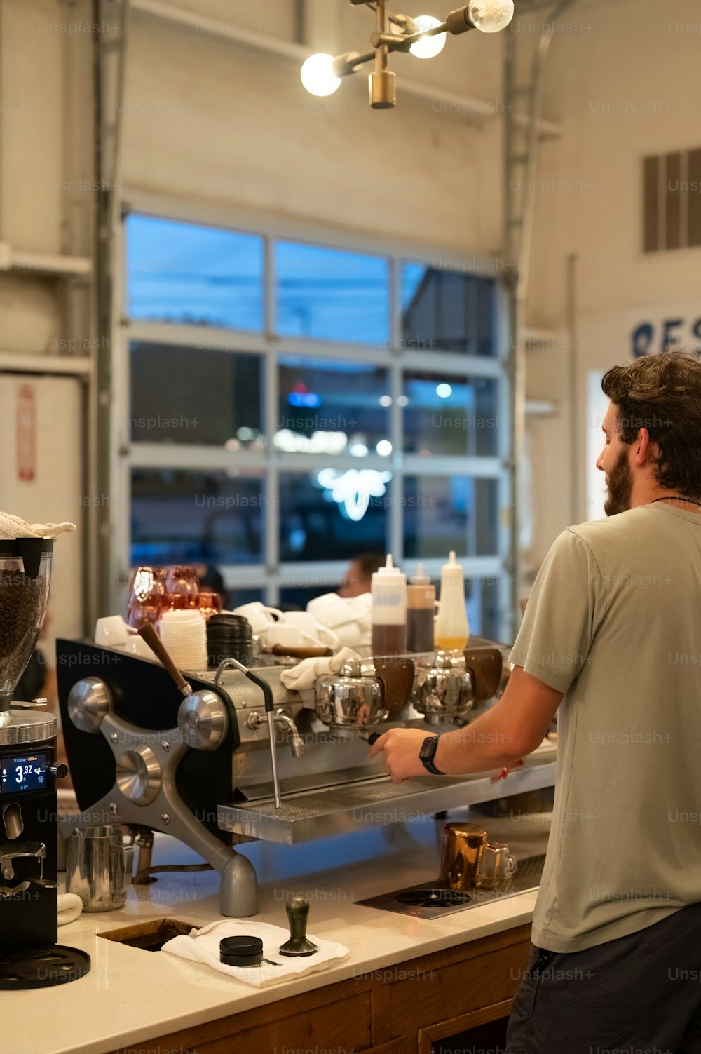 a man standing in front of a coffee machine