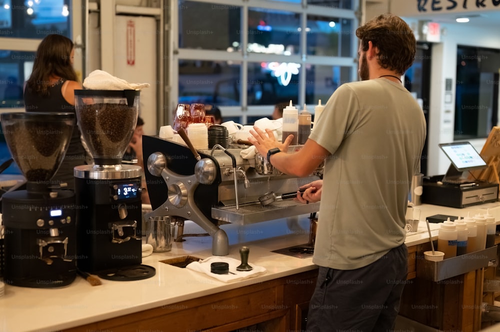 a man standing at a counter in a coffee shop