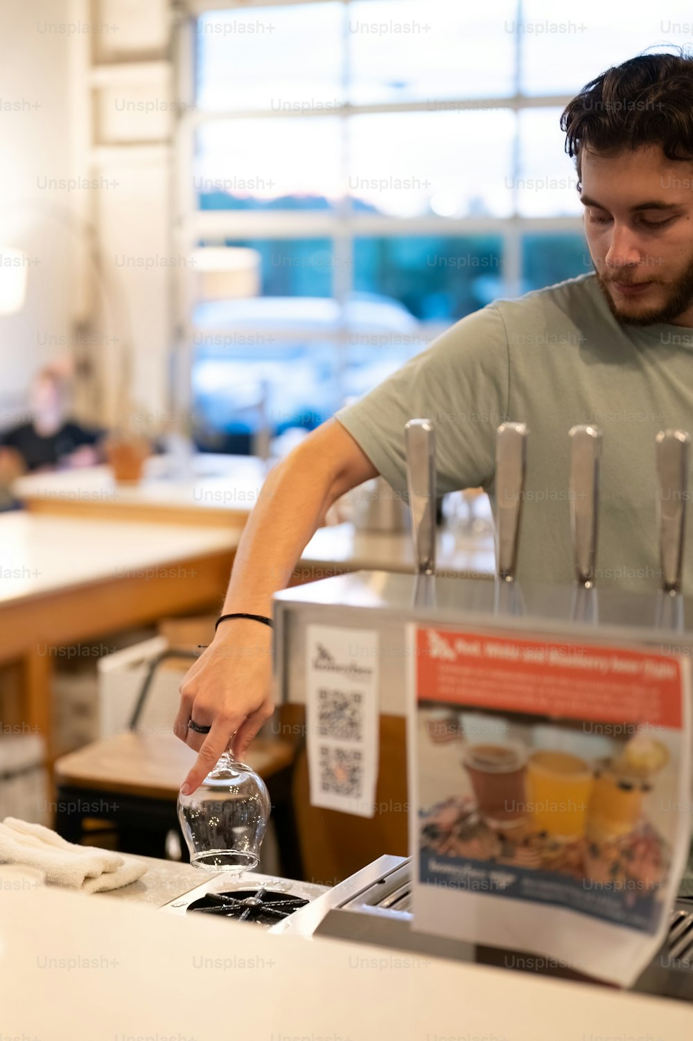 a man is filling a glass with water