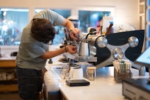 a man working on a machine in a kitchen