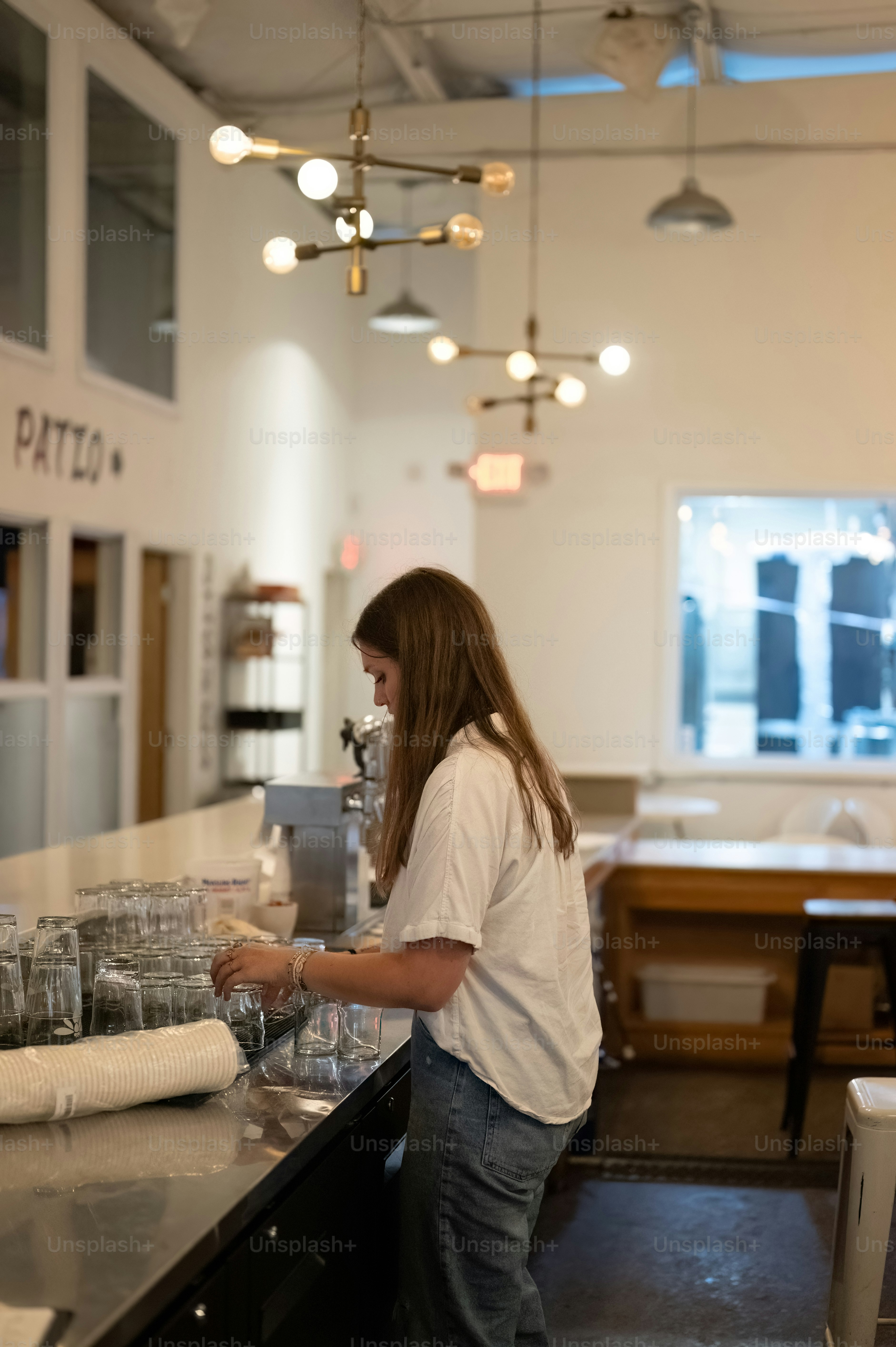 a woman standing at a counter in a restaurant
