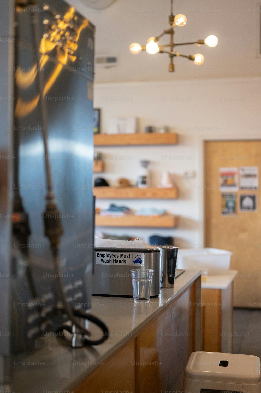 a coffee shop with a coffee maker and cups on the counter