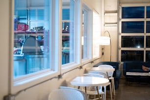 a woman sitting at a table in front of a window