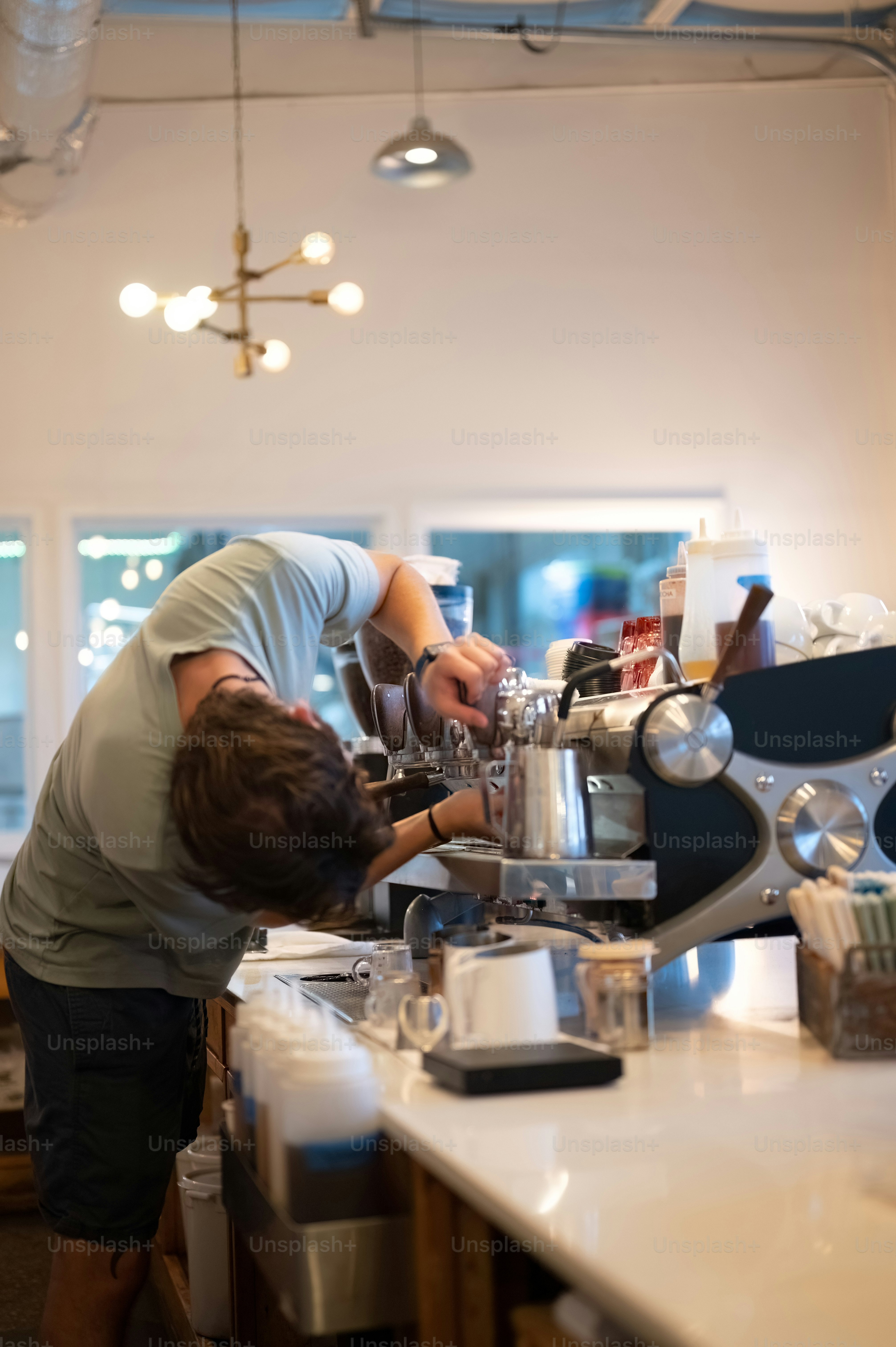 a man is working on a machine in a kitchen