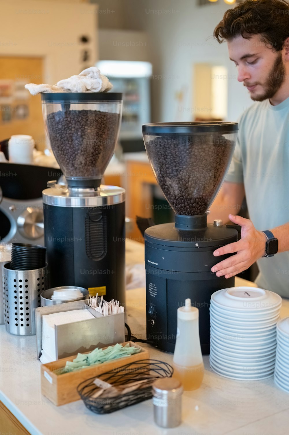 a man standing in front of a coffee maker