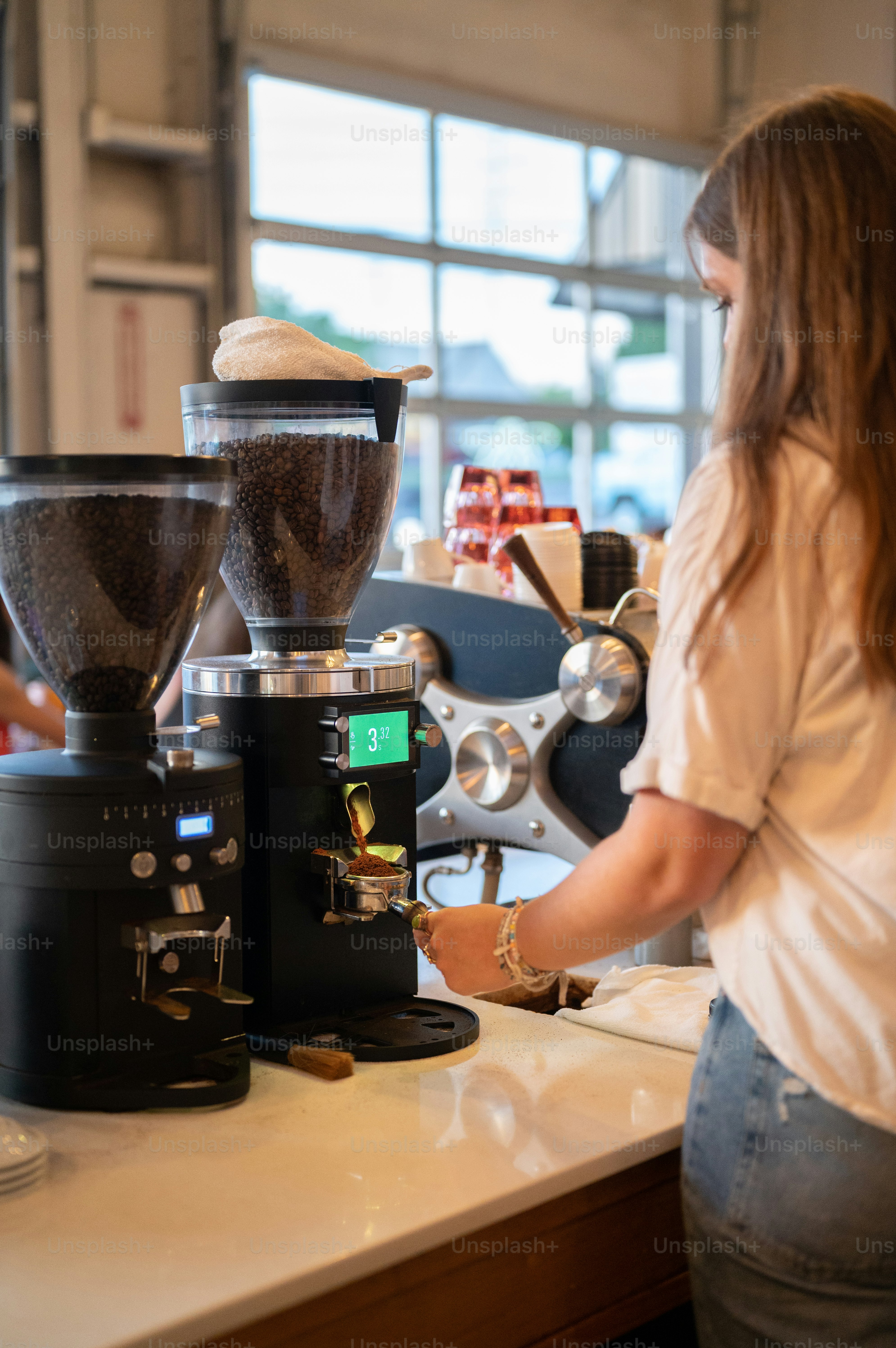 a woman standing in front of a coffee maker