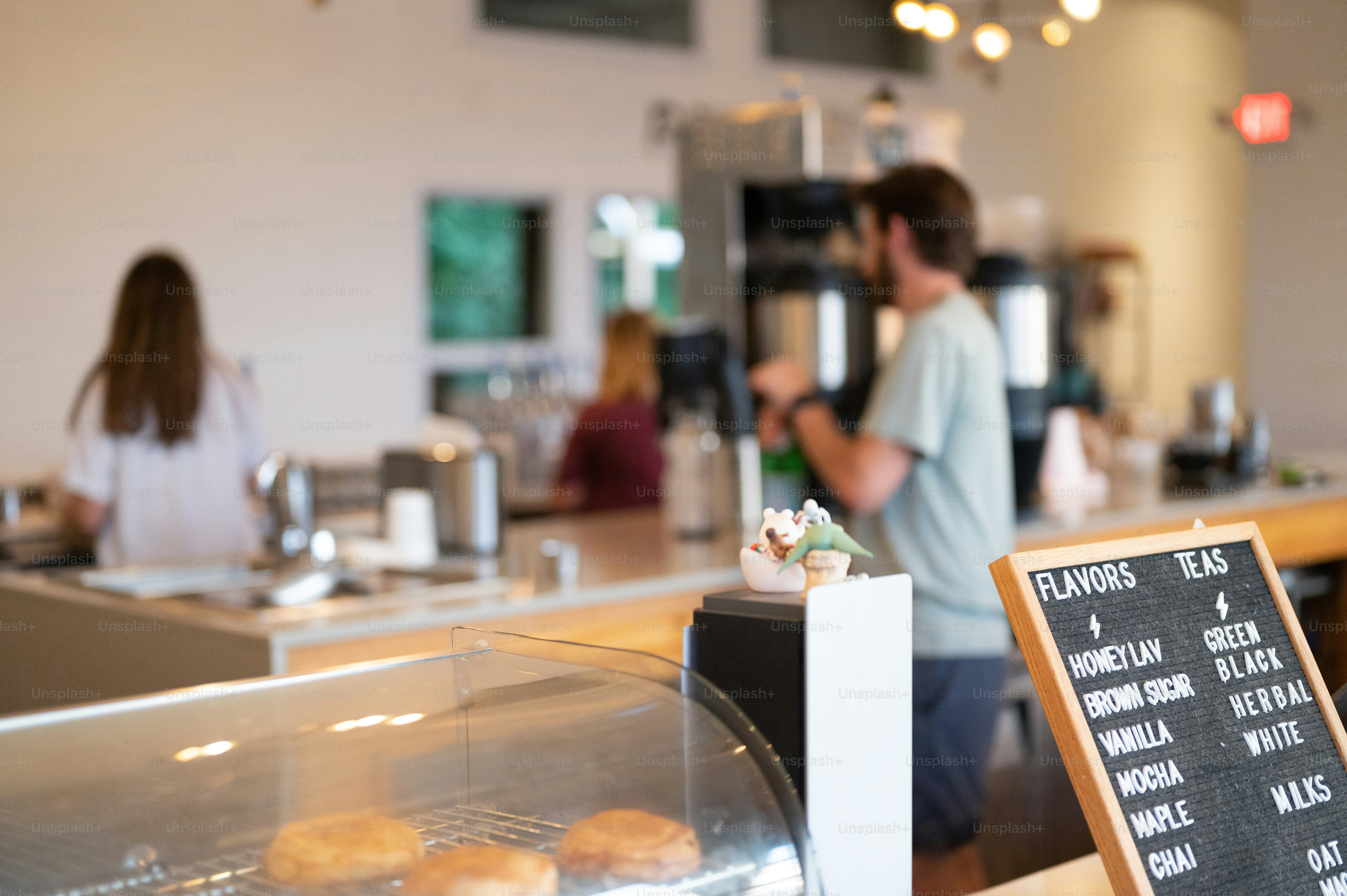 a couple of people standing in front of a counter
