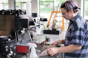 a woman is making a cup of coffee