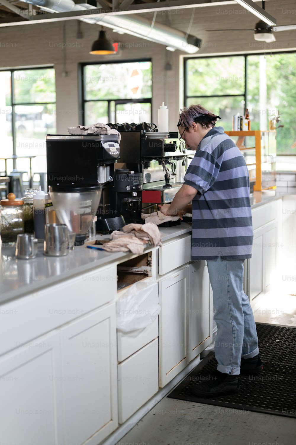 a man standing at a counter in a kitchen