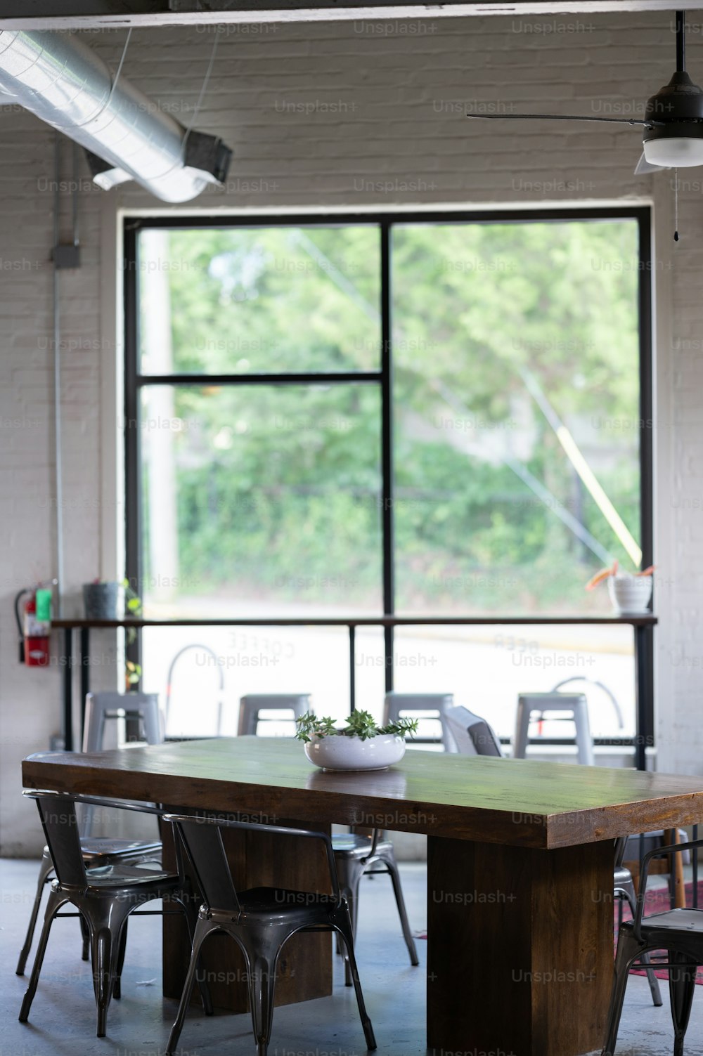 a table and chairs in front of a large window