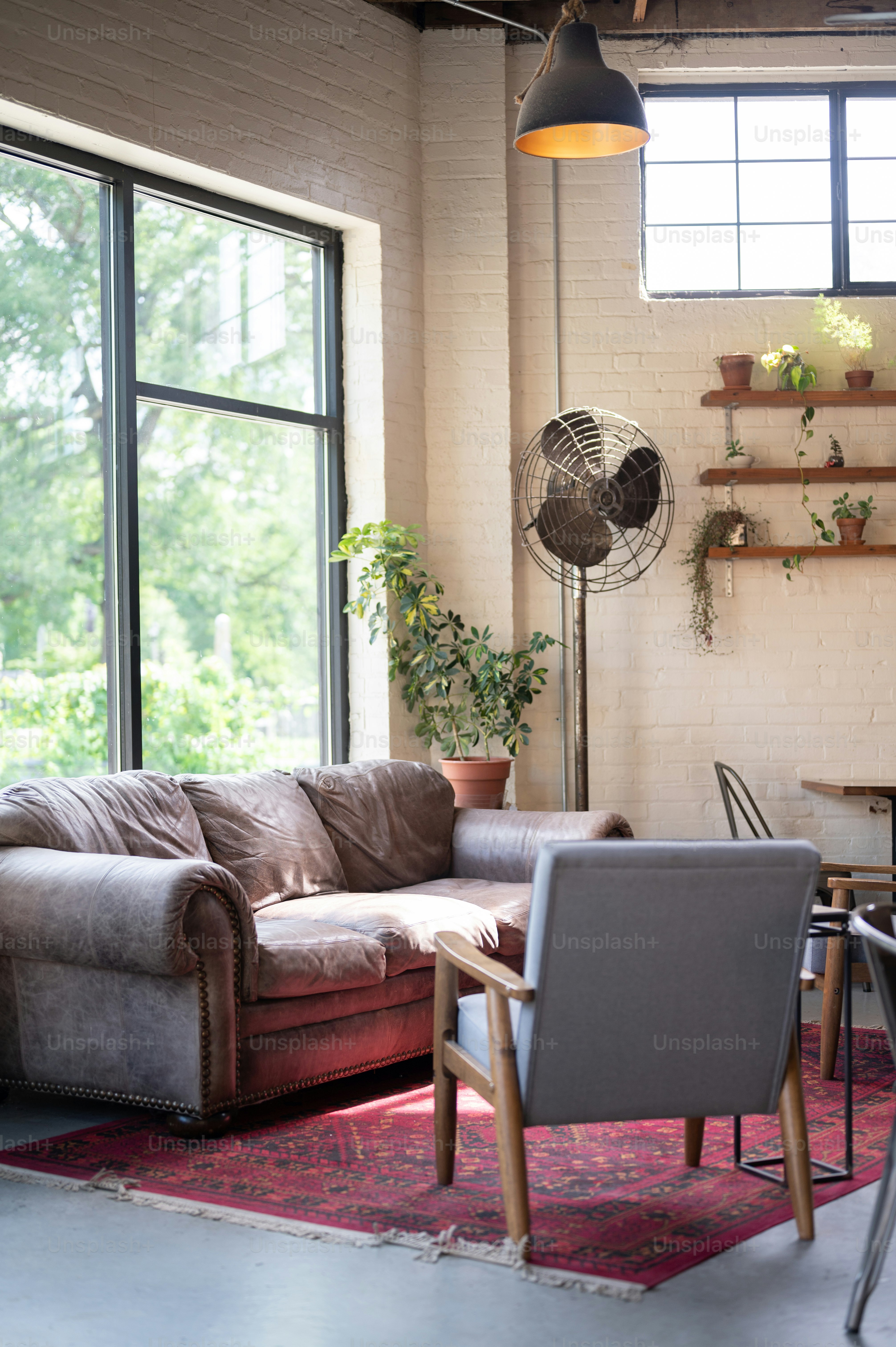 a living room filled with furniture and a fan