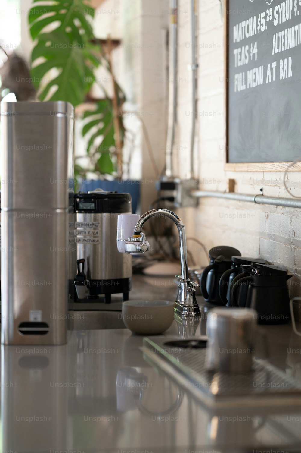 a kitchen counter with a coffee maker and a blender