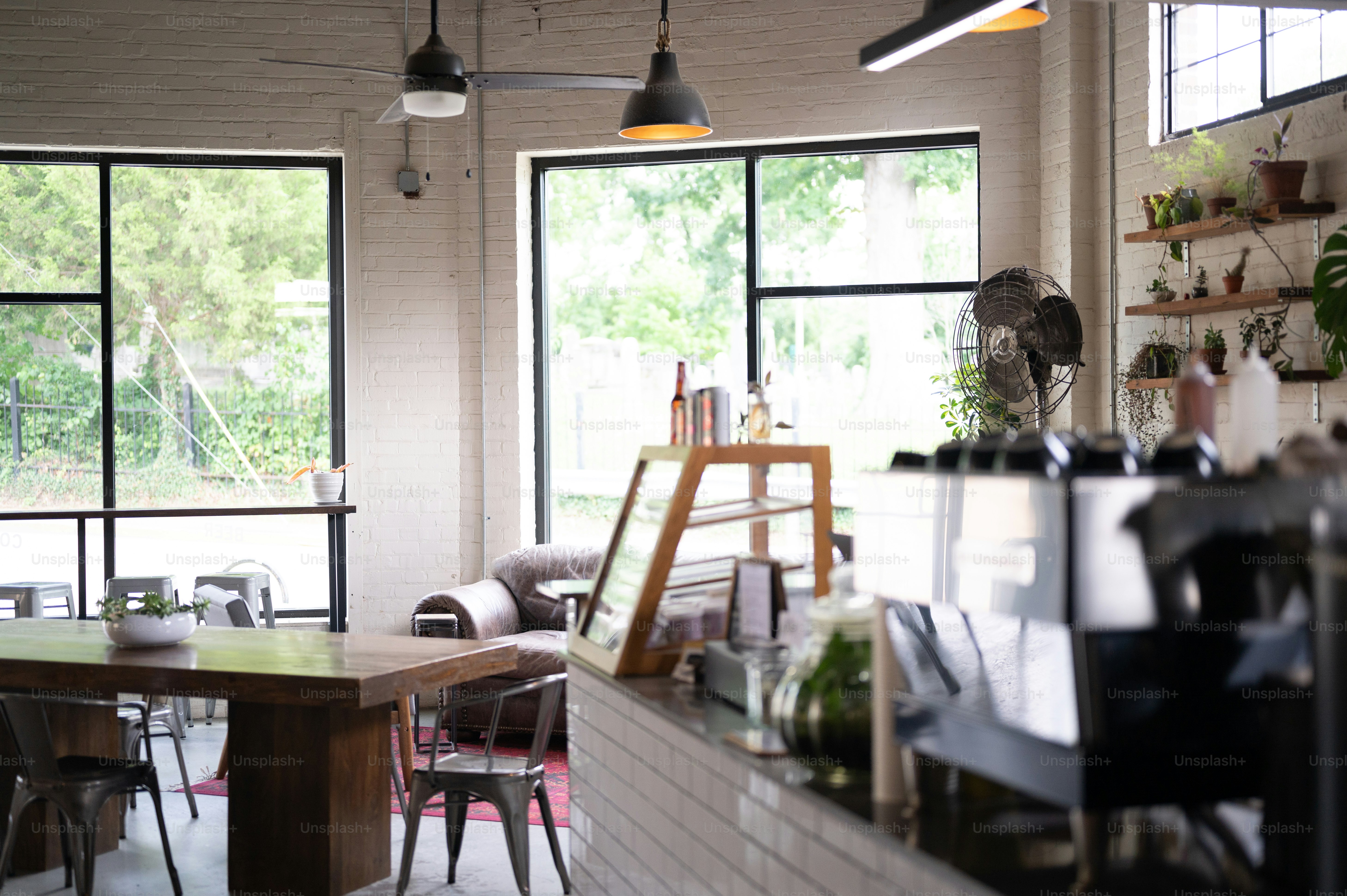 a room filled with lots of furniture and windows