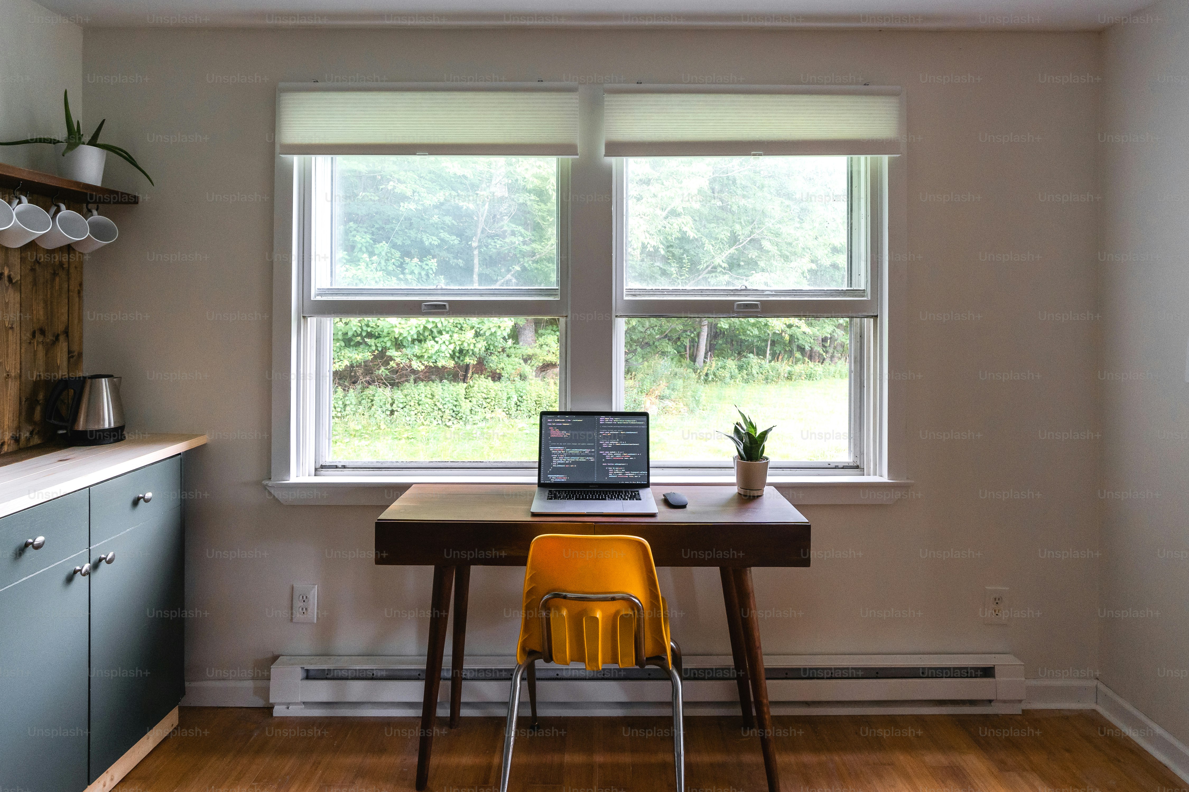 a laptop computer sitting on top of a wooden table