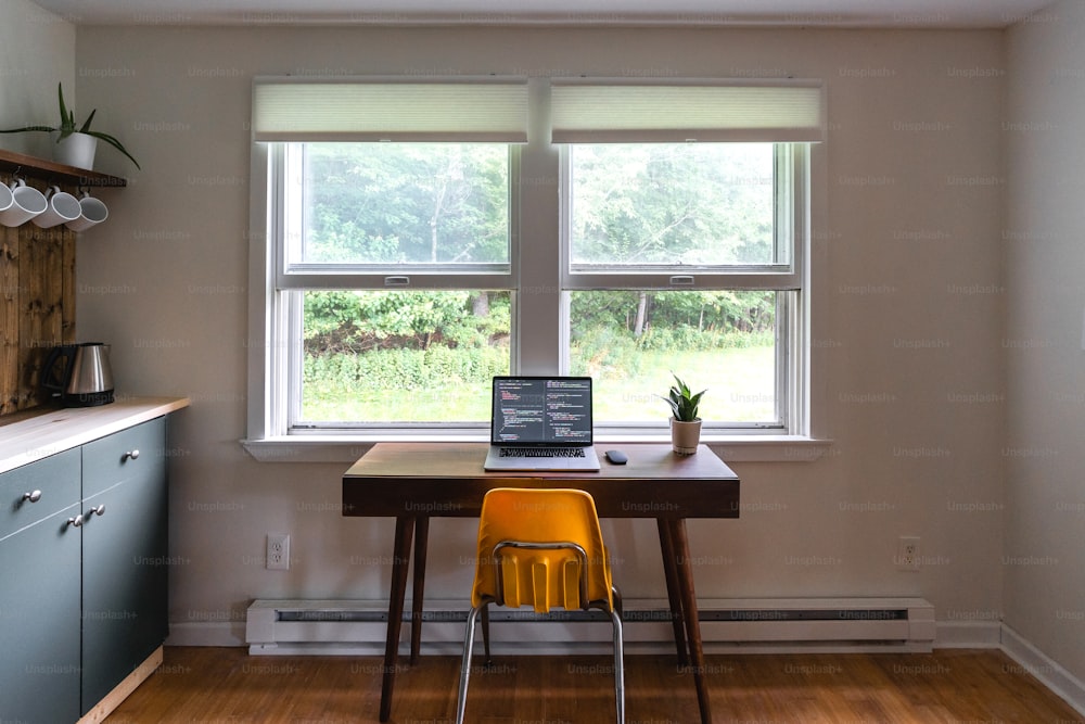 a laptop computer sitting on top of a wooden table