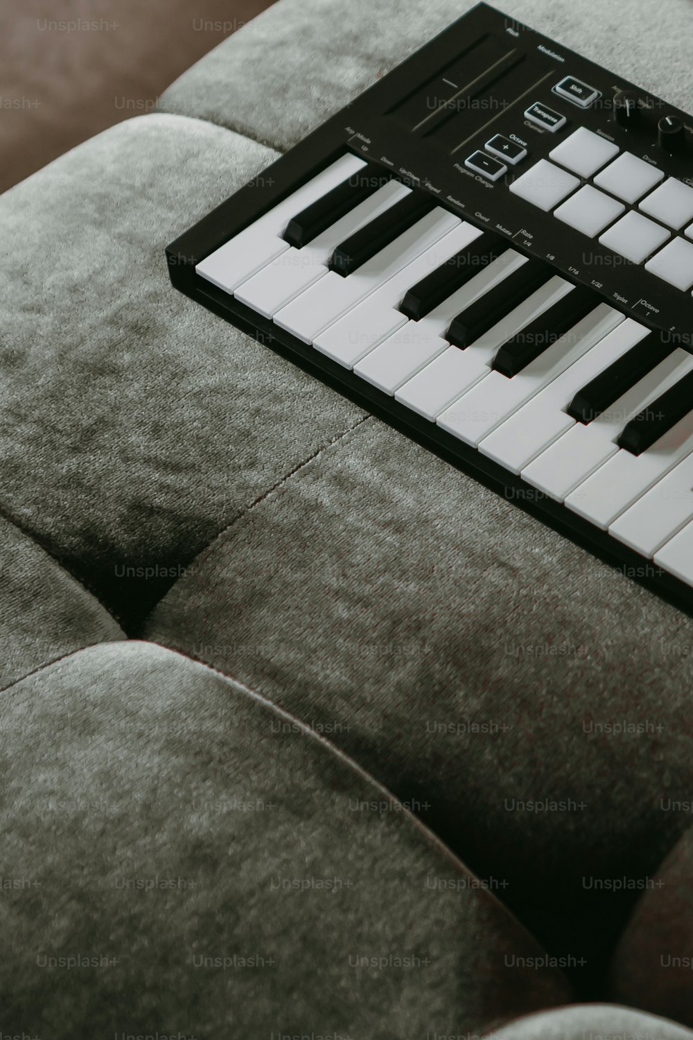 a close up of a piano keyboard on a couch