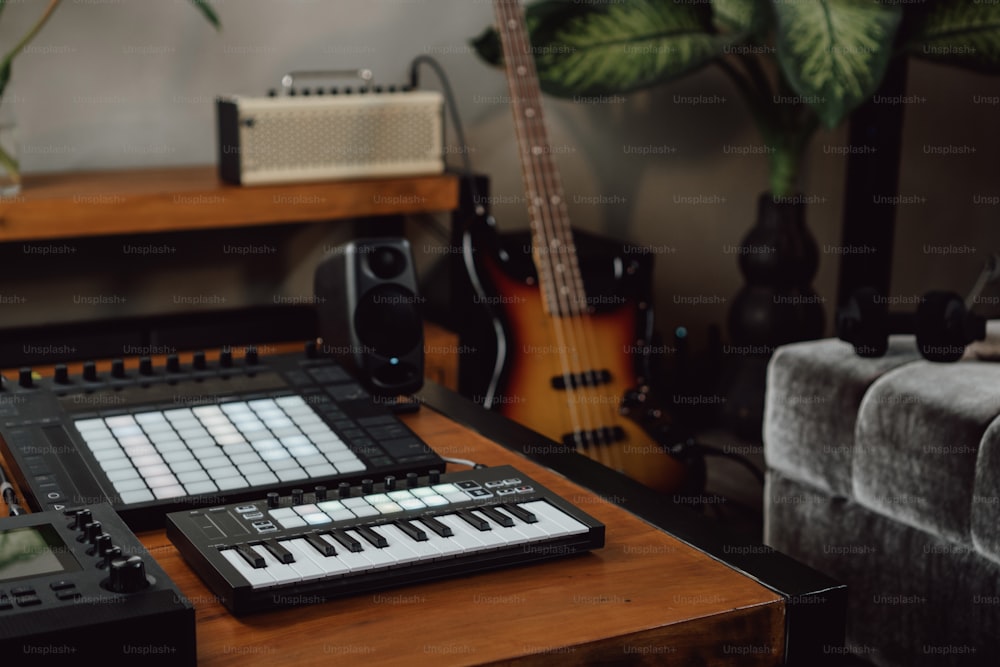 a keyboard and a guitar sit on a table