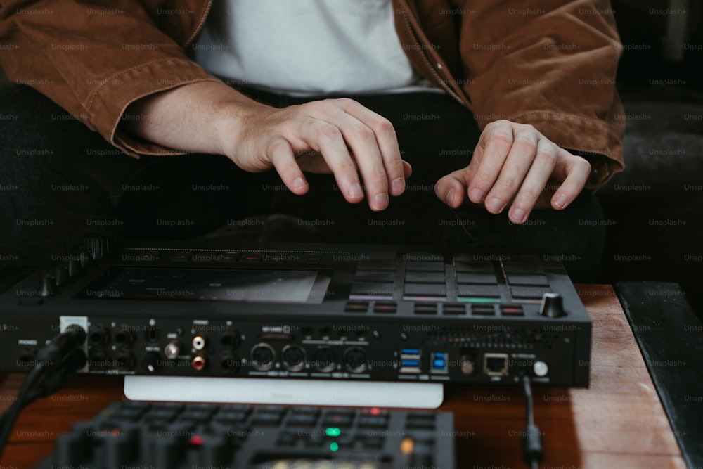 a person sitting in front of a sound board