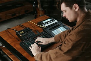 a man sitting at a table working on a keyboard