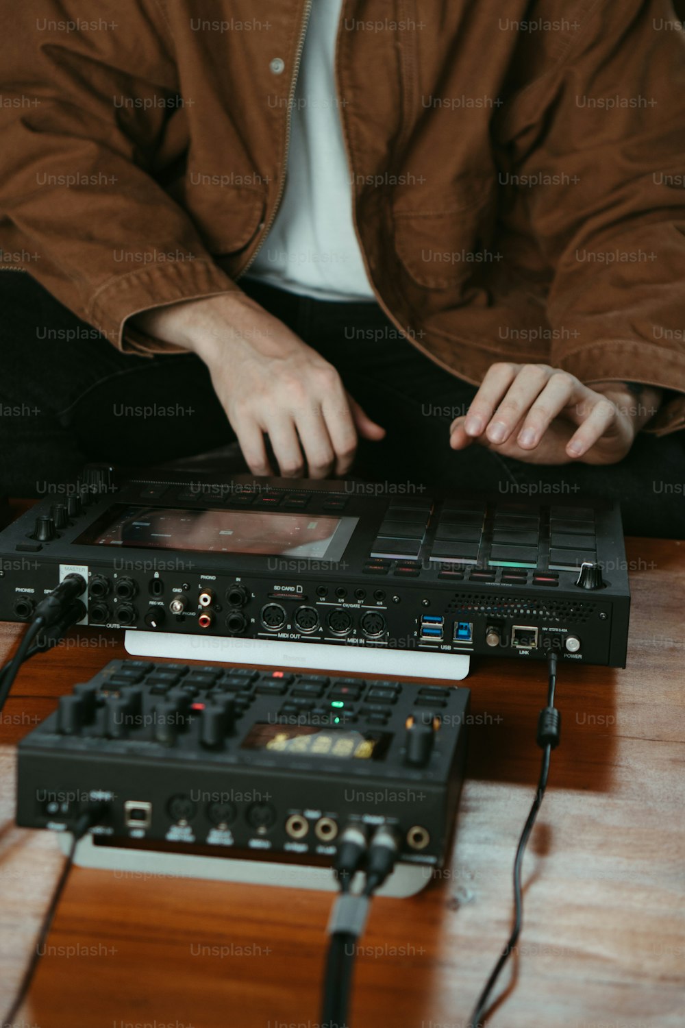 a man sitting at a table working on a sound board