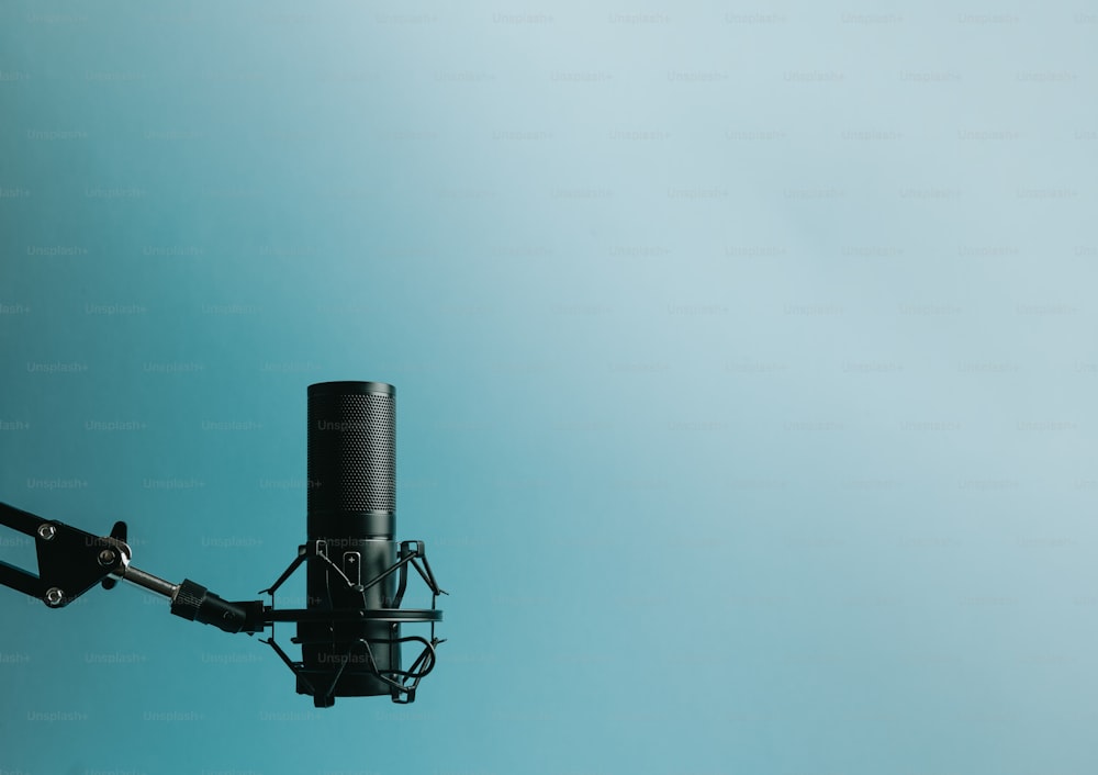 a close up of a microphone with a sky background