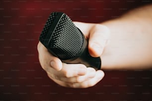 a close up of a person holding a microphone