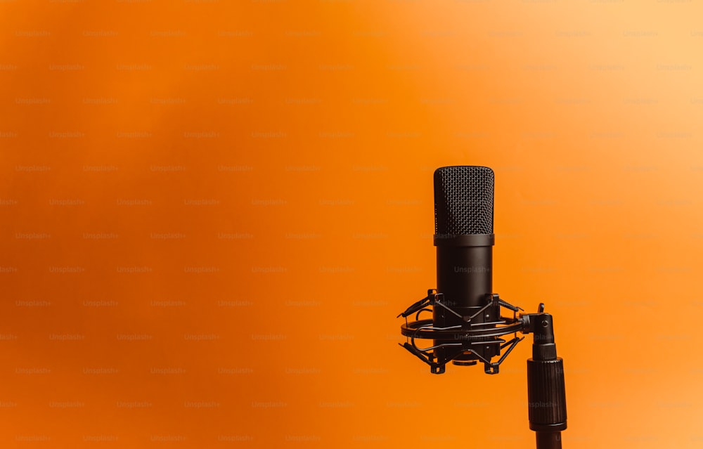 a black microphone with a yellow background