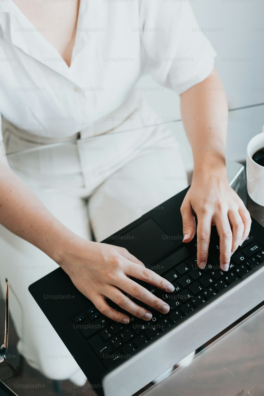 a woman is typing on a computer keyboard