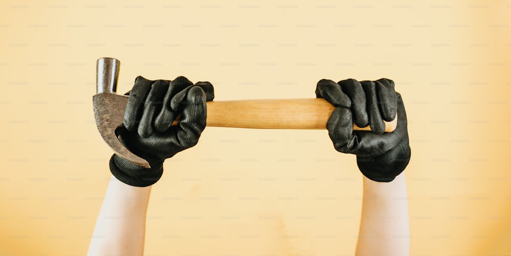 a person holding a hammer in their hands