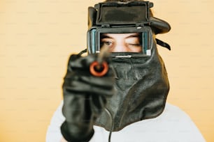 a person wearing a mask and holding a gun