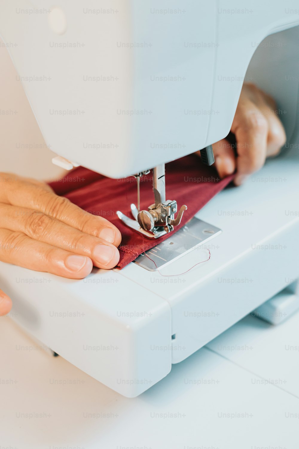 a person using a sewing machine to sew a piece of fabric