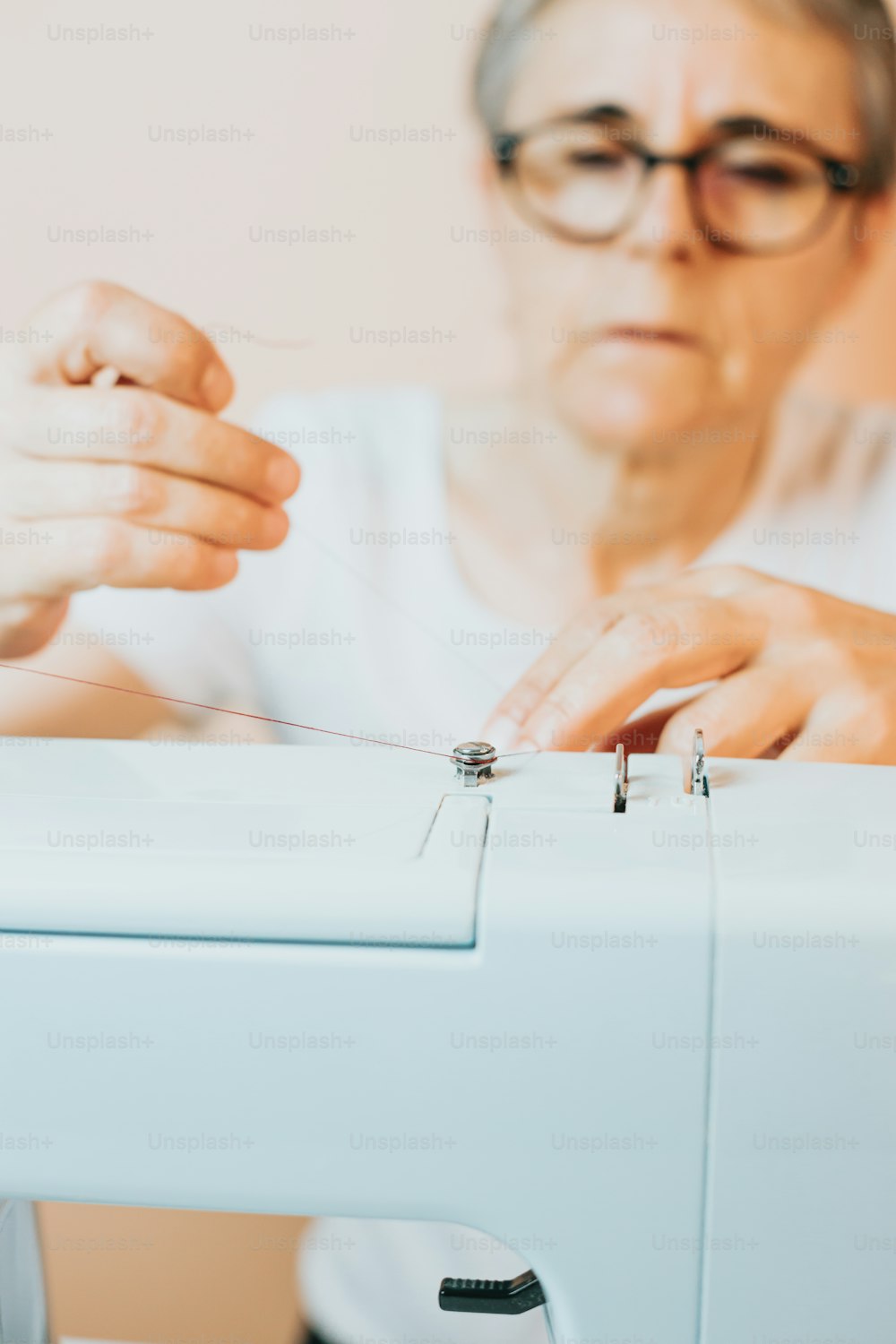 a woman is sewing on a sewing machine