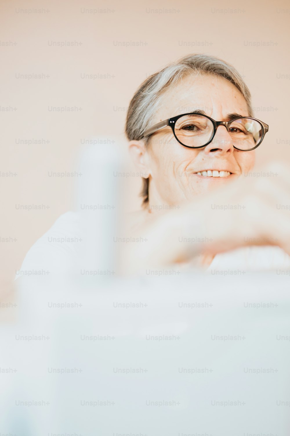 a woman with glasses taking a picture of herself
