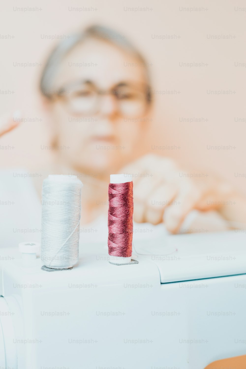 a close up of a sewing machine with a spool of thread