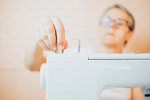 Eine Frau benutzt eine Nähmaschine zum Nähen