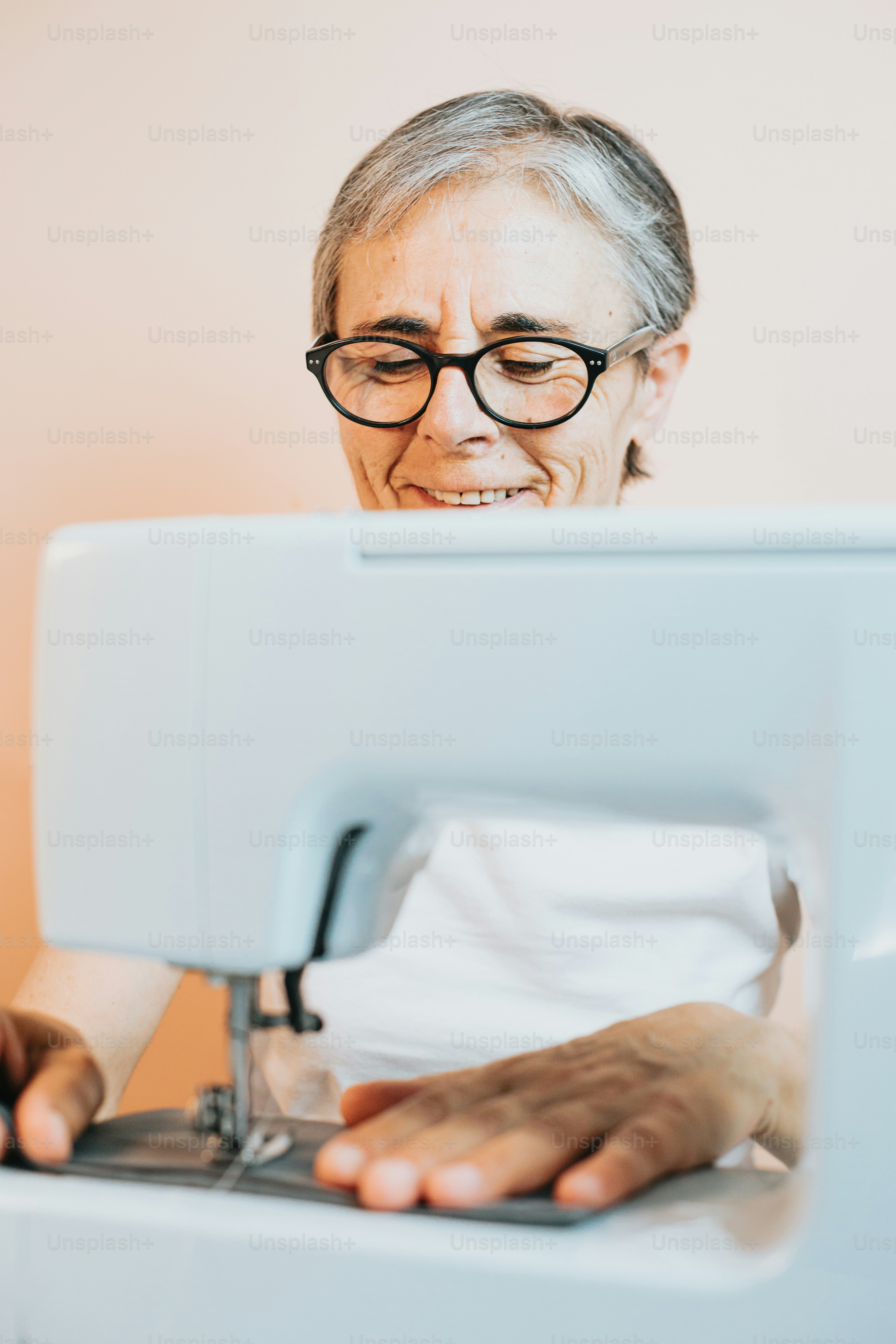 an older woman is using a sewing machine