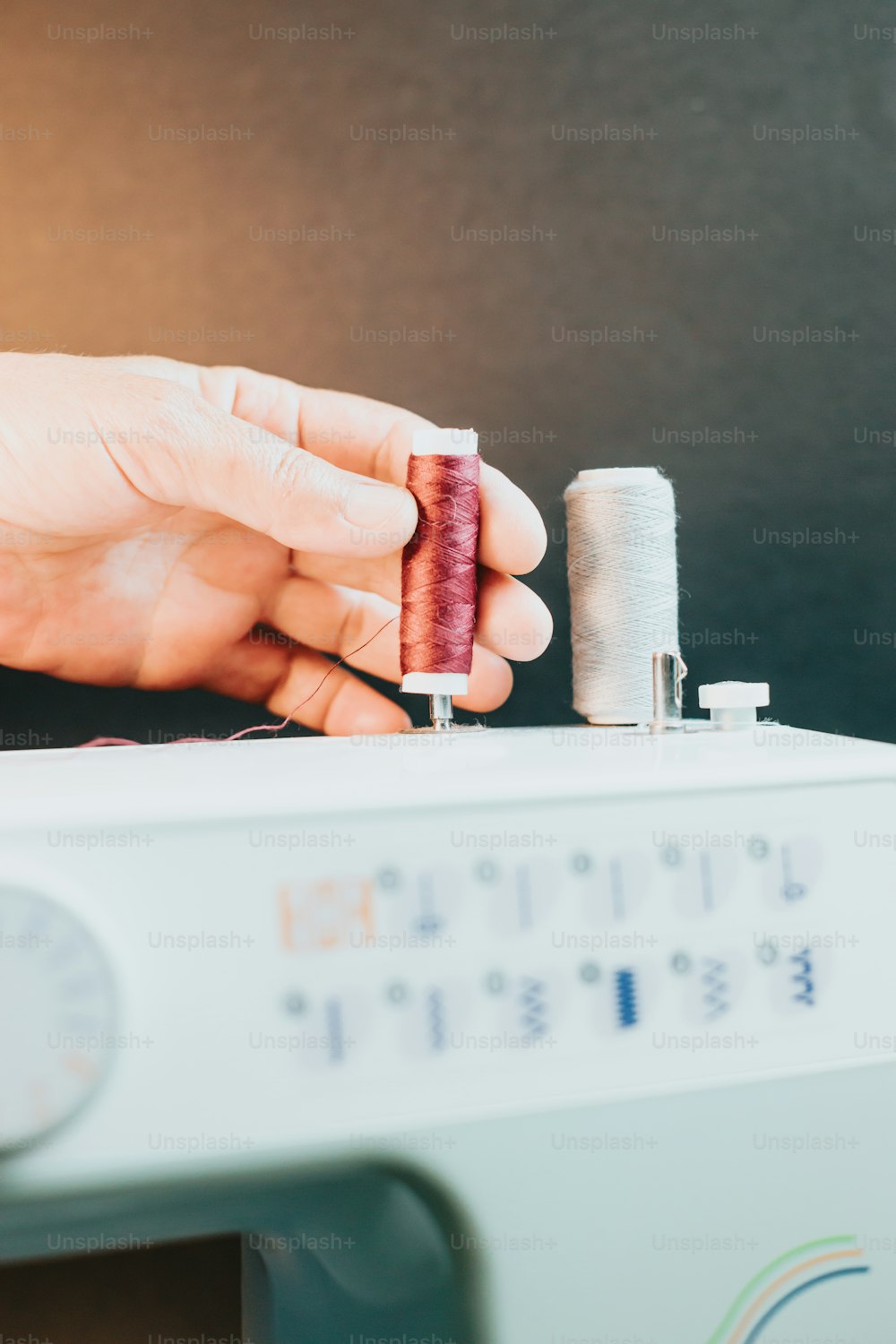 uma pessoa está costurando um pedaço de tecido em uma máquina de costura