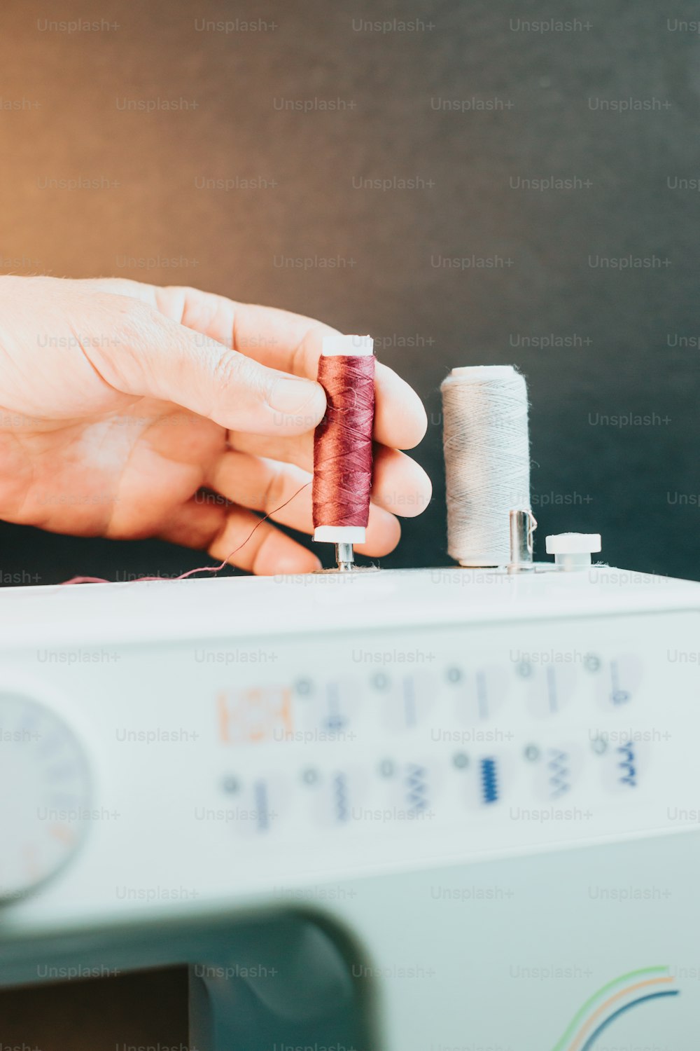 a person is sewing a piece of fabric on a sewing machine