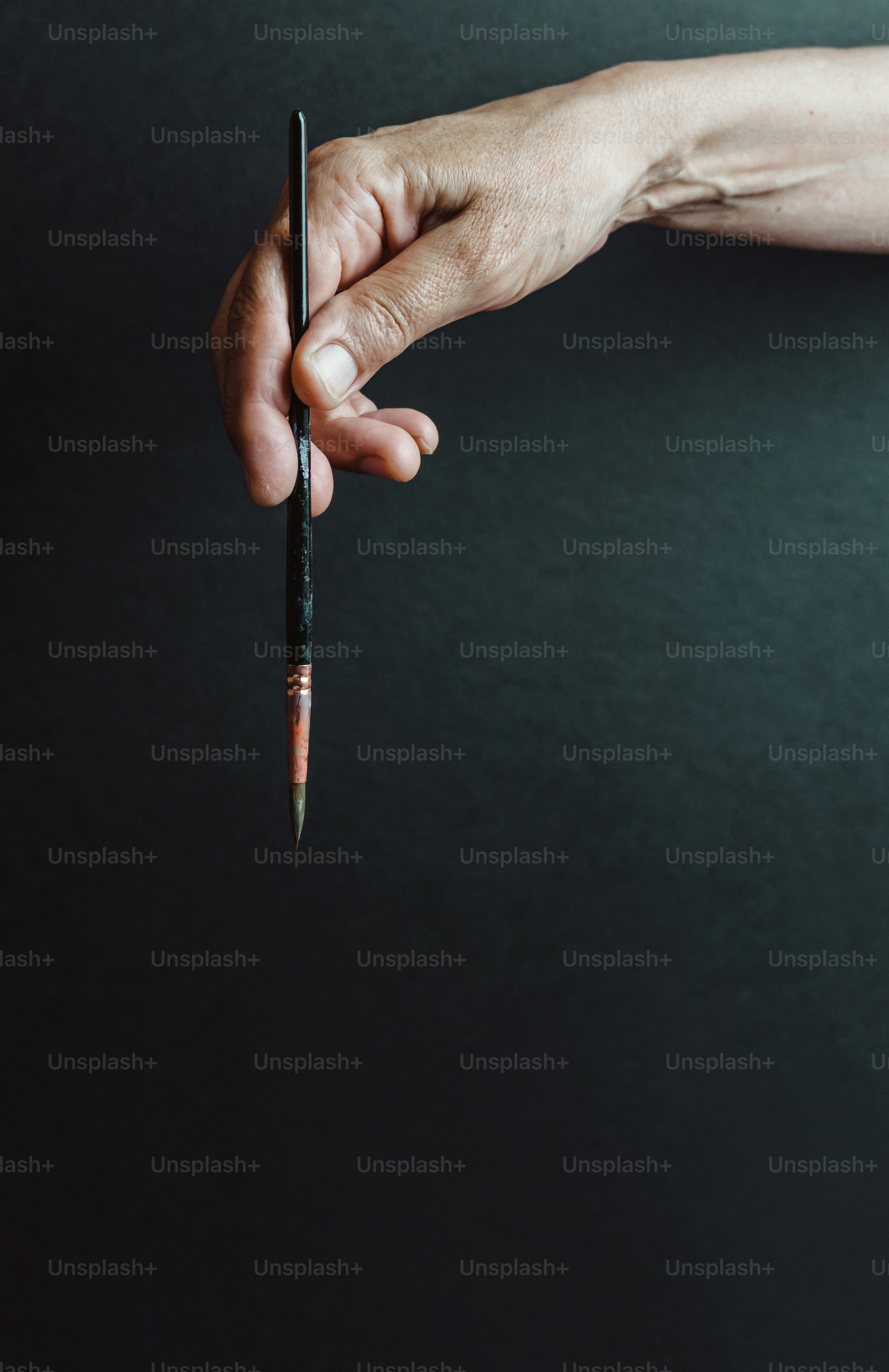 a person holding a pen in their hand