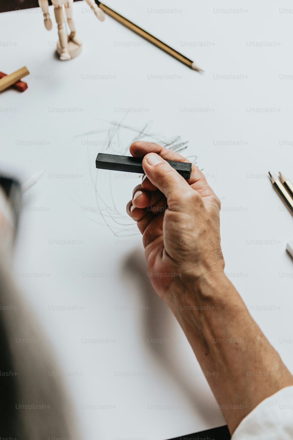 a person is drawing a picture on a piece of paper