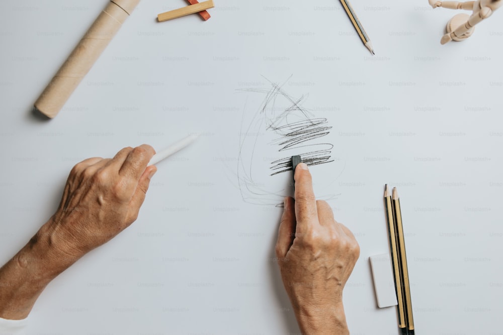 a person drawing on a piece of paper