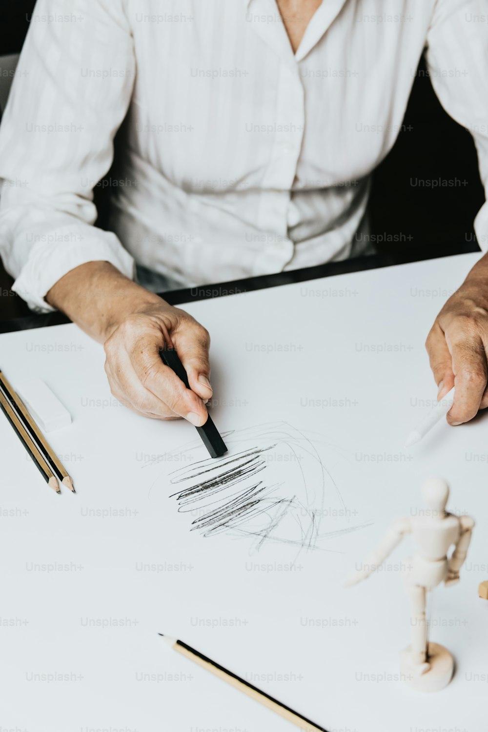 a man is drawing on a piece of paper