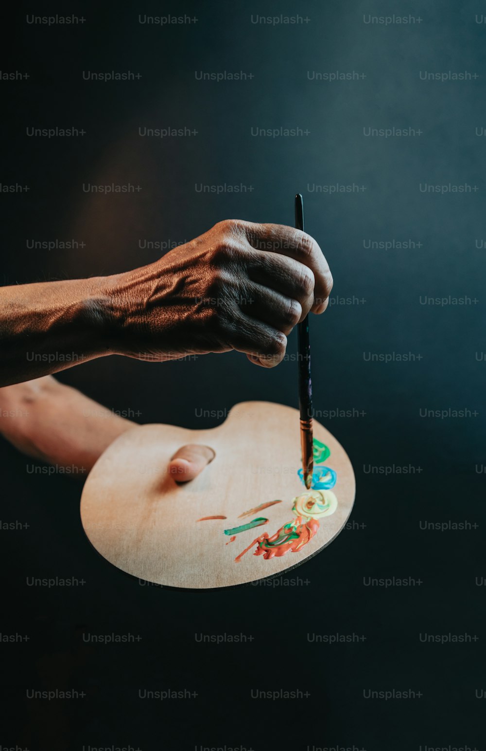 a person holding a paintbrush in their hand