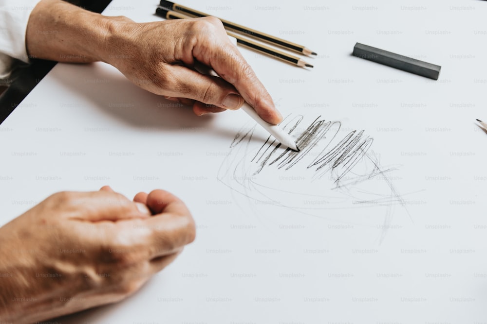 una persona sta disegnando qualcosa su un pezzo di carta