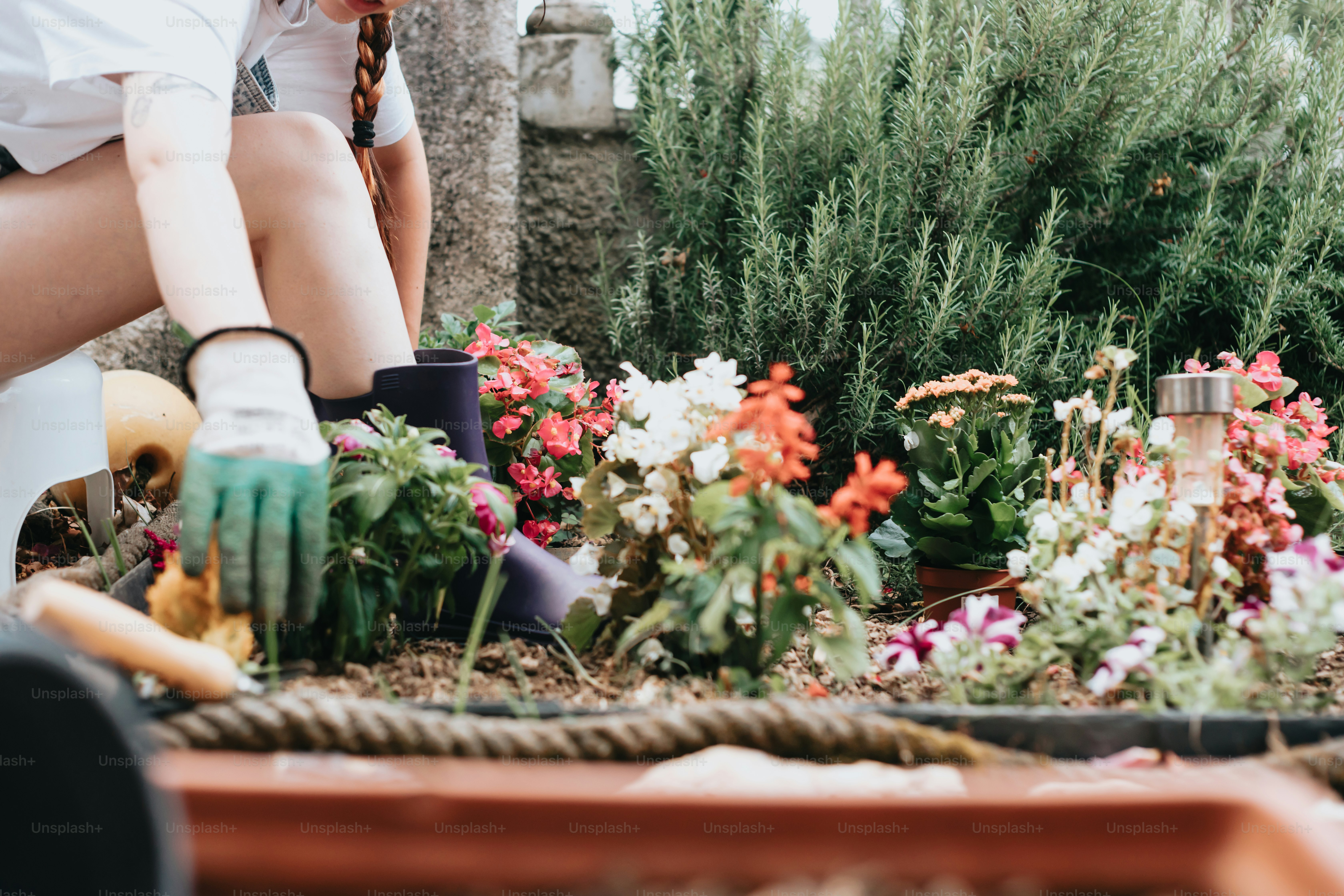 a woman in a white shirt is gardening
