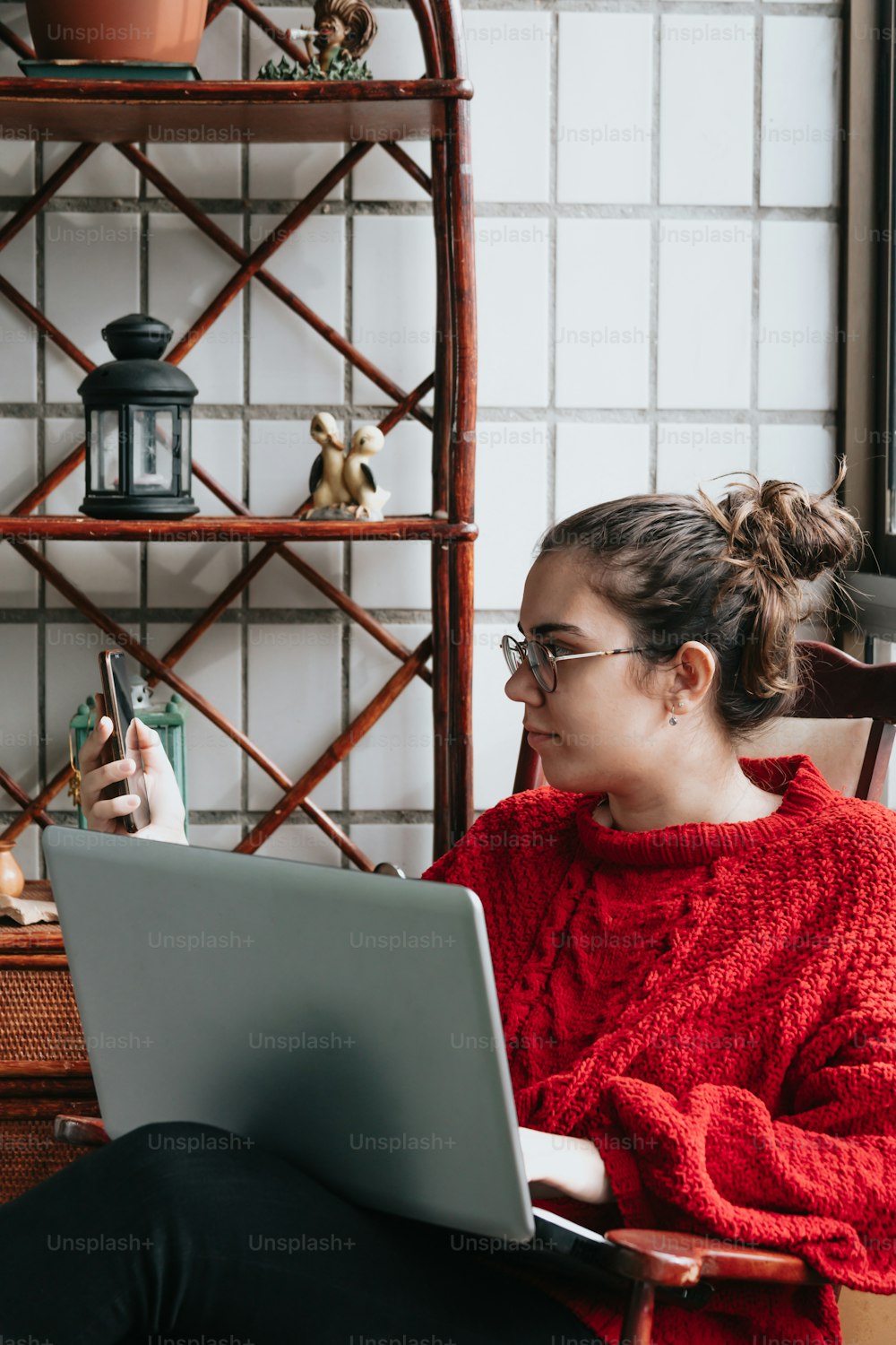 a woman sitting in a chair using a laptop computer