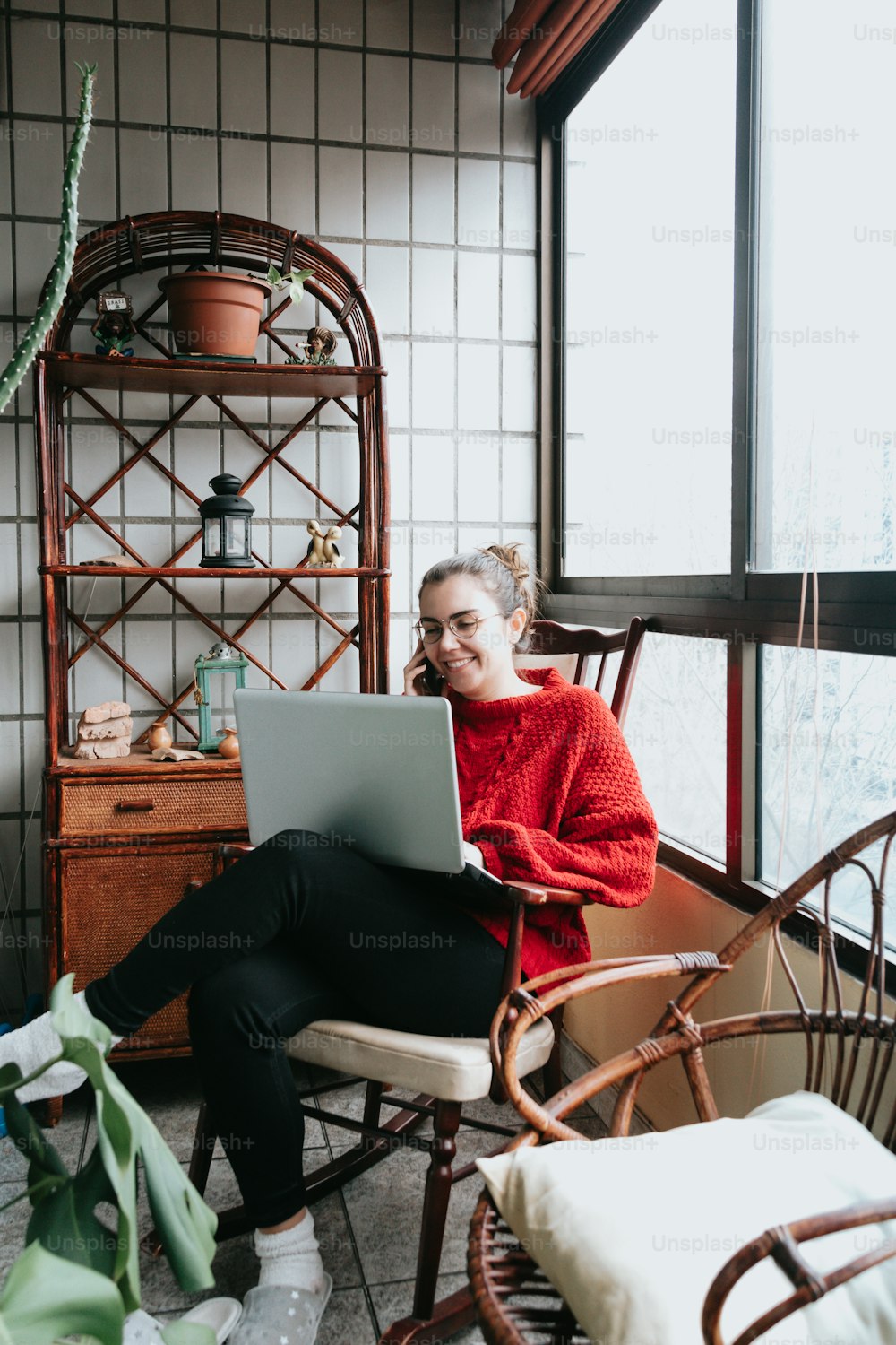 a woman sitting in a chair using a laptop computer