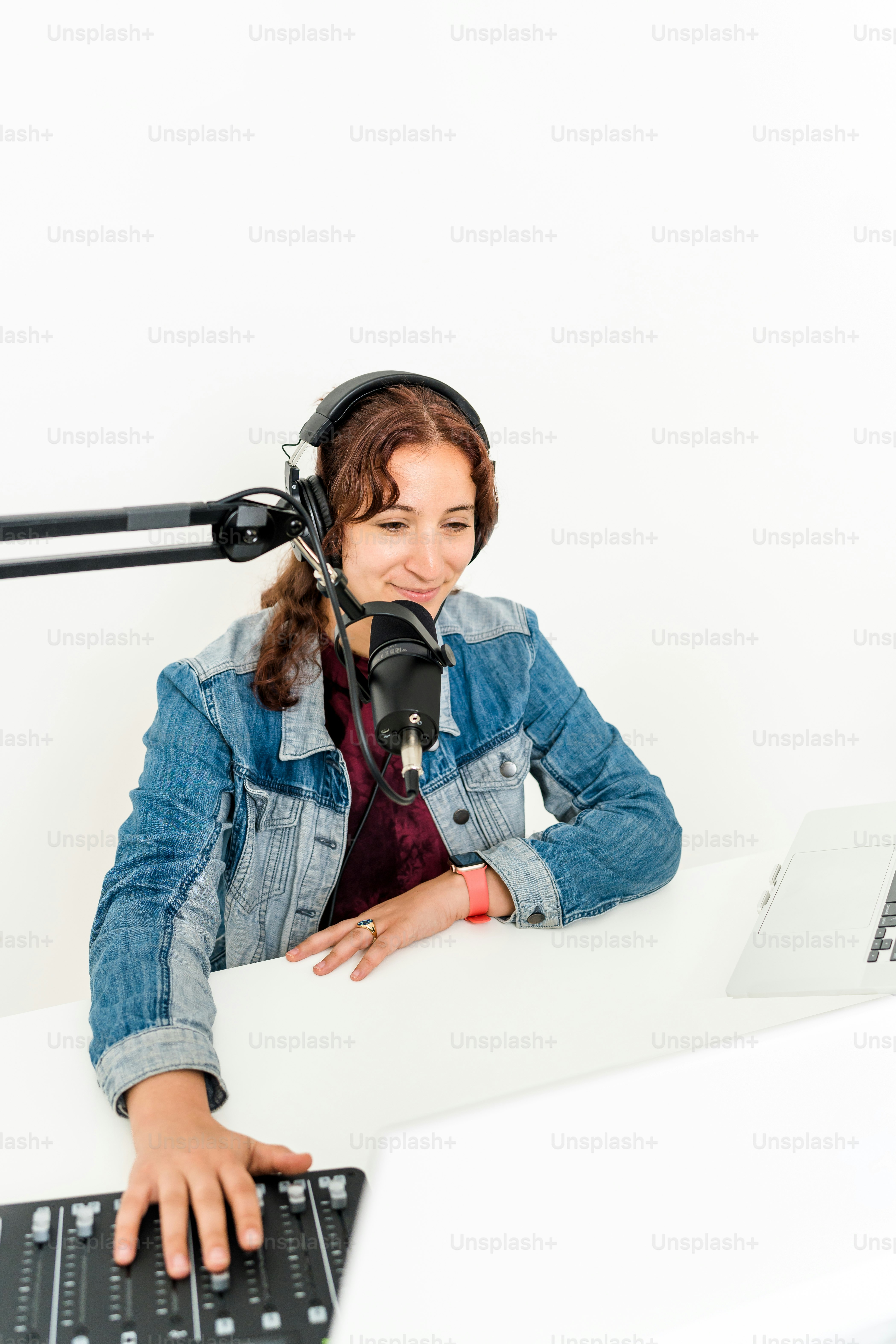 a woman sitting at a desk with headphones on
